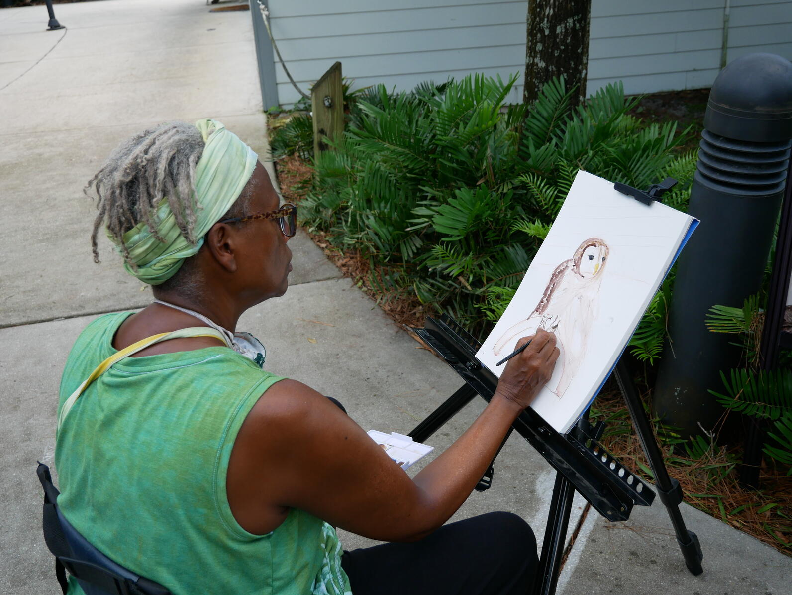 a woman sketching outdoors