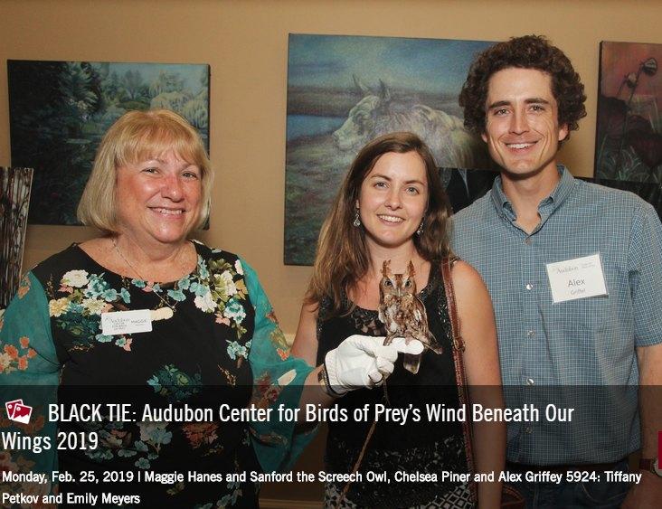 photo of staff and quests with Eastern Screech Owl at event